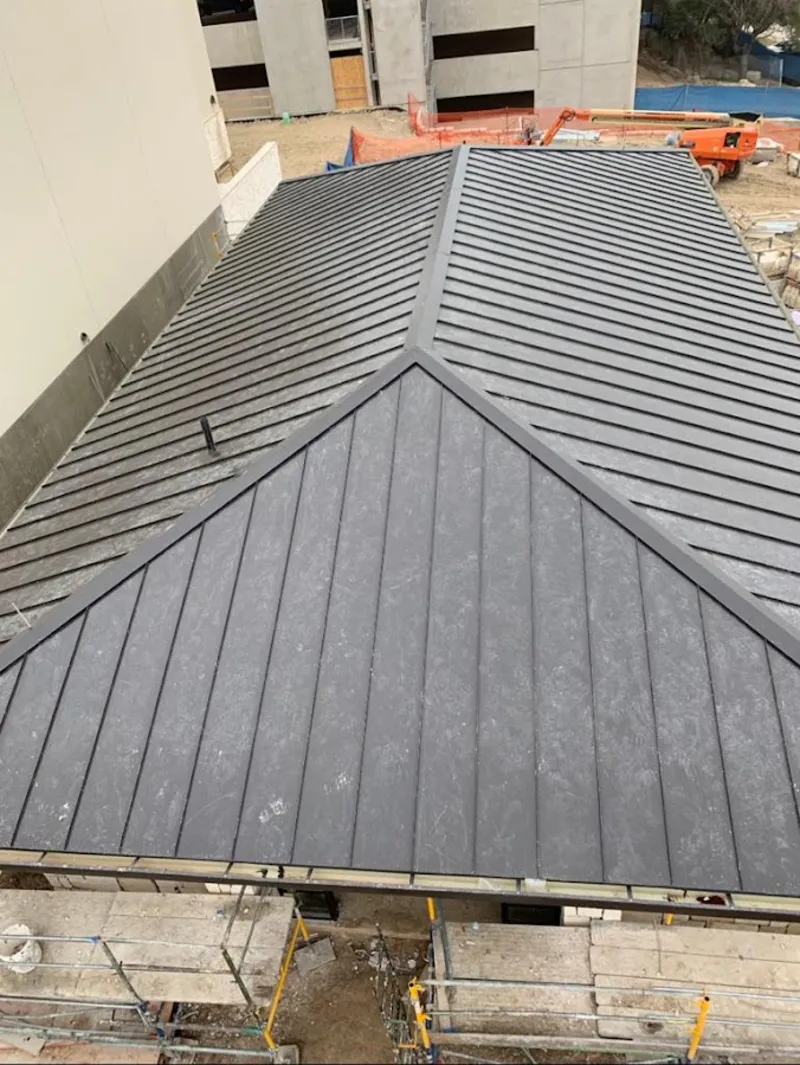 Commercial metal roof construction with crane equipment in Mishawaka